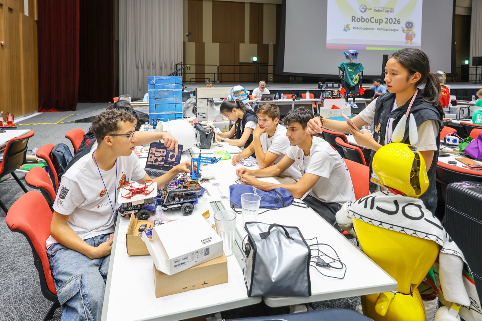 RoboCupJunior teams building their robots at RoboCup 2026, Incheon — the kind of real, defensible project AI can’t fake.